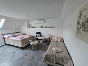 a bedroom with a bed and a table in it at Prostě statek in Skalka