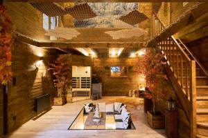 a large living room with a couch and stairs at Les cottages du parc in Roubaix