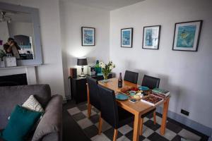 a living room with a table and a couch at Verity and Ilfracombe Harbour View in Barnstaple +20 photos