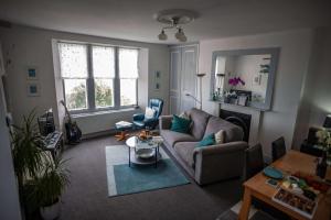 a living room with a couch and a table at Verity and Ilfracombe Harbour View in Barnstaple