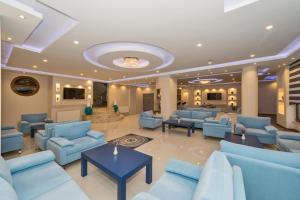 a large lobby with blue couches and tables at Hotel Selenay in Istanbul