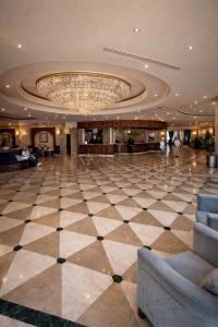 a large lobby with a large chandelier in a building at Grand Tibarose Hotel in Cairo +71 photos