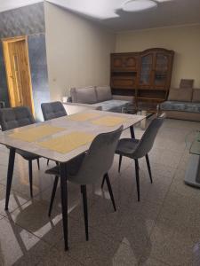 a room with a table and chairs and a couch at Rent Olamit in Šančiai