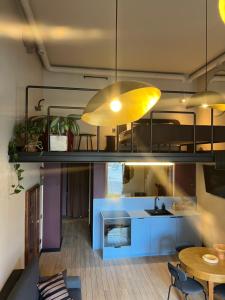 a living room with a loft bed and a table at G Loft - Spacious Urban Apartment with Bathtub and Private Entrance in Kaunas