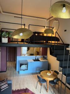 a room with a bunk bed and a table and chairs at G Loft - Spacious Urban Apartment with Bathtub and Private Entrance in Kaunas