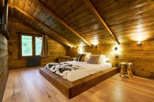 a bedroom with a bed in a wooden cabin at Les cottages du parc in Roubaix +22 photos