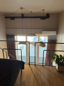 a bedroom with a bed and a large window at G Loft - Spacious Urban Apartment with Bathtub and Private Entrance in Kaunas +9 photos