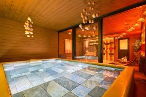a swimming pool in the middle of a house at Les cottages du parc in Roubaix