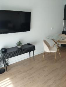 a living room with a black table and chairs at Amazing Studio Close to Oldtown in Gdańsk
