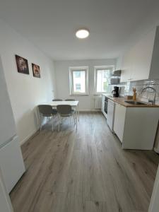 a kitchen with a table and chairs in a room at Ruheblick Apartment Essen in Essen