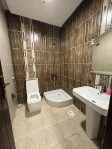 a bathroom with a toilet and a sink at Talya Apartment in Mecca +15 photos