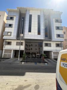 a building with a van parked in front of it at Talya Apartment in Mecca