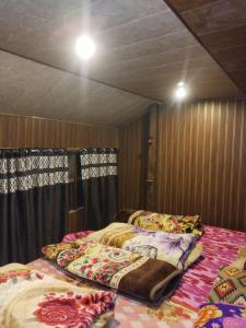 a room with two beds in a room with curtains at Himalayan siddhi yog aashram in Badrinath