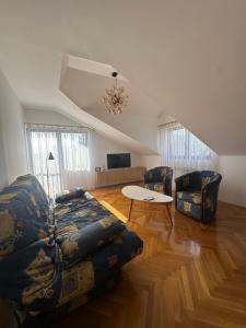 a living room with a couch and a table at Grand apartman in Banja Luka +3 photos