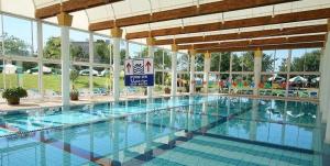 a large swimming pool in a large building at Pure Bliss Caesarea - אושר טהור בקיסריה in Caesarea