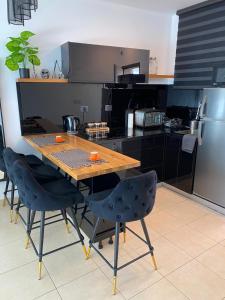 a kitchen with a wooden table and chairs at Pure Bliss Caesarea - אושר טהור בקיסריה in Caesarea