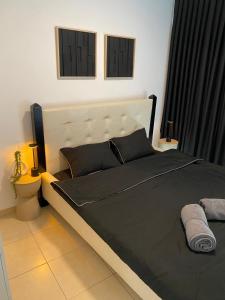 a bedroom with a large bed with a black blanket at Pure Bliss Caesarea - אושר טהור בקיסריה in Caesarea +10 photos