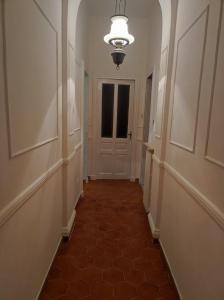 an empty hallway with a door and a tile floor at Maison Platone Jolie in Alessandria