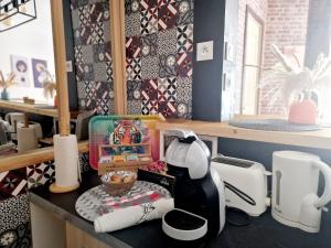 a kitchen counter with a coffee maker on top of it at Cosy atelier in Vierzon