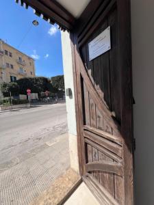 a door to a building with a sign on it at In Villa - Dimora Liberty in Gravina in Puglia