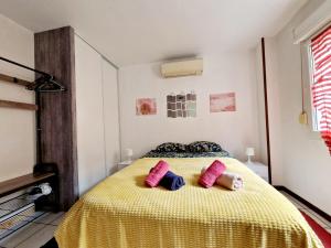 a bedroom with a bed with two pillows on it at Cosy atelier in Vierzon