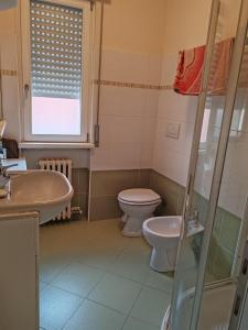 a bathroom with a toilet and a sink at La casa di Viola in Bardolino +10 photos