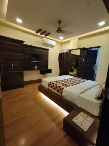 a bedroom with a bed in a room with wooden floors at hotel shree shyam palace in Ujjain