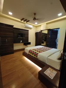 a bedroom with a bed in a room with wooden floors at hotel shree shyam palace in Ujjain