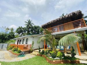 a house with a thatched roof at Birbeck Lodge in Bulusan