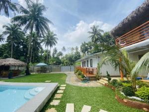 a house with a yard with a swimming pool at Birbeck Lodge in Bulusan