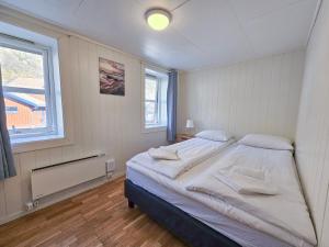 a bedroom with a bed and a window at Apartment close to the mountain in Svolvær