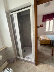 a bathroom with a shower with a glass door at Le camere del Baldo parcheggio gratuito in centro storico in Peschiera del Garda +34 photos