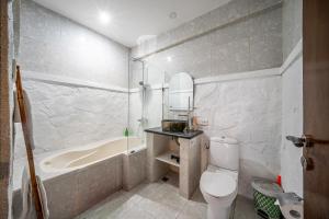 a bathroom with a tub and a toilet and a sink at Villa Papat Seminyak in Seminyak +11 photos