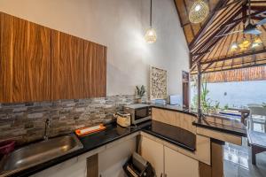 a kitchen with a sink and a counter top at Villa Papat Seminyak in Seminyak