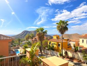 a view of a city with palm trees and mountains at Villa Chayofa in Chayofa