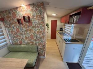 a small kitchen with a couch in a tiny house at Glamping Lodge Estartit in L'Estartit