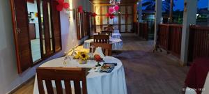 a row of tables in a restaurant with red balloons at EcoResorTamarino in M. Peixe