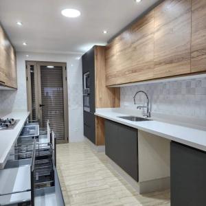 a kitchen with a sink and a counter top at Apartment Modern zeganrif in Segangane