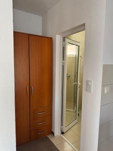 a bathroom with a wooden cabinet and a mirror at Guest House Ugljevarevic in Budva +54 photos