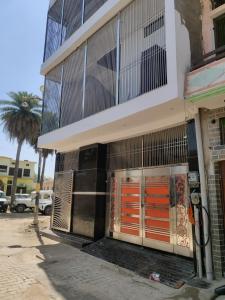 a building with orange doors on the side of it at Suryavanshi Guest House in Ayodhya
