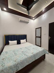 a bedroom with a large bed with a ceiling fan at Suryavanshi Guest House in Ayodhya +61 photos