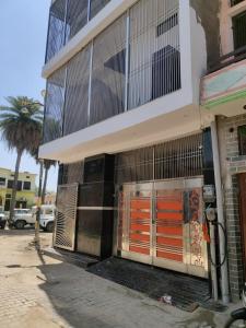 a building with orange doors on the side of it at Suryavanshi Guest House in Ayodhya