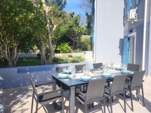 a dining table and chairs on a patio at Casa Solis Losinj in Mali Lošinj