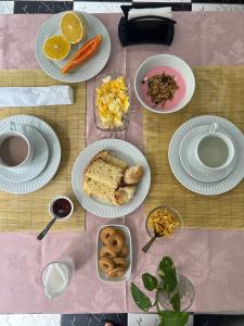 a table with plates of food on top at Pousada Shamah - Morro de São Paulo in Morro de São Paulo +31 photos