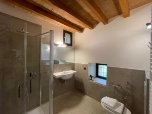 a bathroom with a shower toilet and a sink at La Torre Masana in Vigostano +21 photos