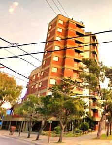 a tall apartment building with trees in front of it at San Bernardo in San Bernardo