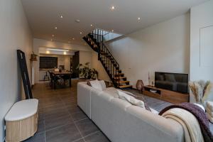 a living room with a couch and a television at BnB 26 in Blankenberge