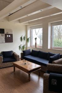 a living room with a couch and a coffee table at Vier Jahreszeiten Hotel in Husum