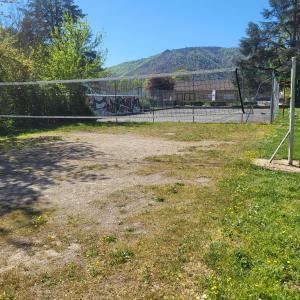 an empty field with a fence and a soccer goal at Le Pakitoun in Boisse-Penchot