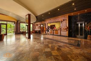 a large lobby with a person walking in the distance at Asean Resort - Shiki Onsen & Spa in Na Nội +100 photos